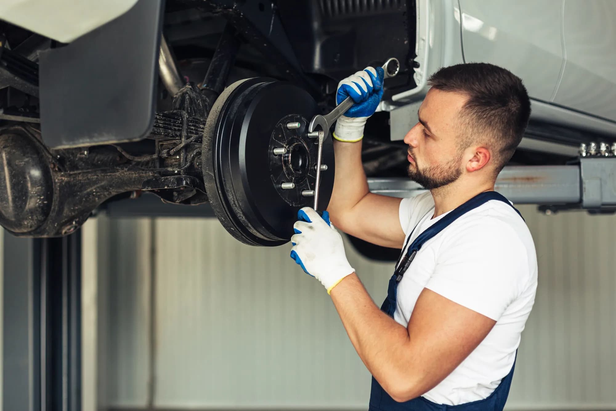 Mechanic replacing brake pads and rotors